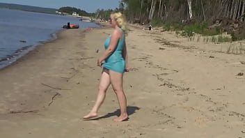 Milf teases pussy on the beach