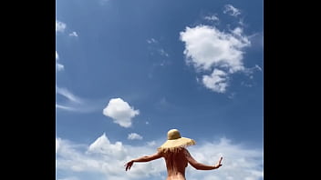 Sexy stepmother walks naked in the field