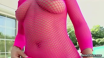 MILF in pink fishnet dress fucking big cock outdoors