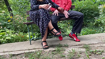 Hot MILF jerks off a big dick into a glass in the park on a bench